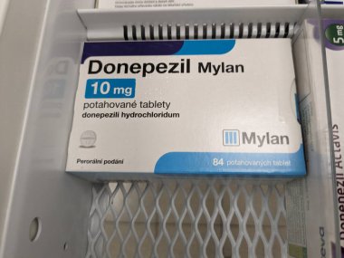 Prague, Czech Republic - July 10 2024: DONEPEZIL MYLAN box of medication with DONEPEZIL active substance by MYLAN, used for treatment of Alzheimer's disease and dementia. clipart