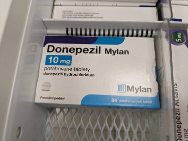 Prague, Czech Republic - July 10 2024: DONEPEZIL MYLAN box of medication with DONEPEZIL active substance by MYLAN, used for treatment of Alzheimer's disease and dementia. clipart