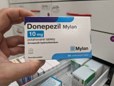 Prague, Czech Republic - July 10 2024: DONEPEZIL MYLAN box of medication with DONEPEZIL active substance by MYLAN, used for treatment of Alzheimer's disease and dementia. clipart