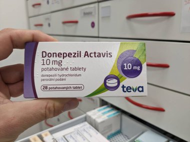 Prague, Czech Republic - July 10 2024: DONEPEZIL ACTAVIS box of medication with DONEPEZIL active substance by ACTAVIS, used for treatment of Alzheimer's disease and dementia. clipart