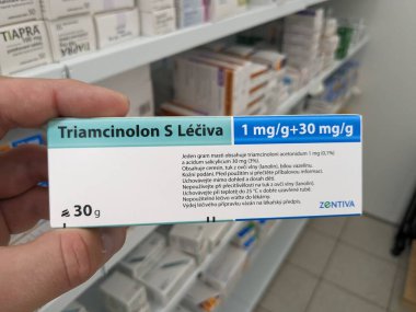 Prague, Czech Republic - July 9 2024: TRIAMCINOLON S box of ointment with TRIAMCINOLONE active substance by STADA, used for treatment of inflammation and allergies. clipart