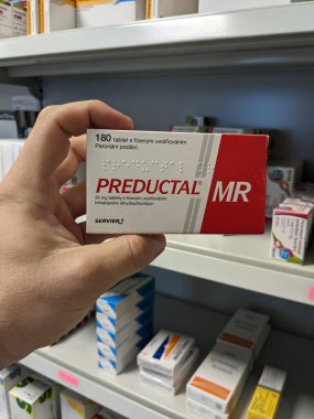 Prague, Czech Republic - July 9 2024: PREDUCTAL box of tablets with TRIMETAZIDINE active substance by SERVIER, used for treatment of angina pectoris and heart disease. clipart