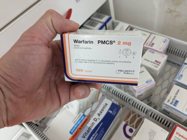 Prague, Czech Republic - July 10 2024: WARFARIN PMCS box of medication with WARFARIN active substance by PMCS, used for prevention and treatment of blood clots. clipart