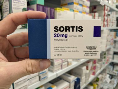 Prague, Czech Republic - July 10 2024: SORTIS box of medication with ATORVASTATIN active substance by PFIZER, used for treatment of hyperlipidemia and cardiovascular disease prevention. clipart