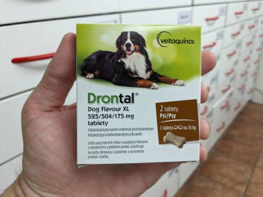 Prague, Czech Republic - July 13, 2024: DRONTAL tablets with PRAZIQUANTEL and PYRANTEL active substances by BAYER, used for deworming pets. clipart