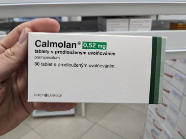 Prague, Czech Republic - August 28 2024: CALMOLAN box with PRAMIPEXOLE active substance by GEROT LANNACH, used for Parkinsons disease and restless legs syndrome. clipart