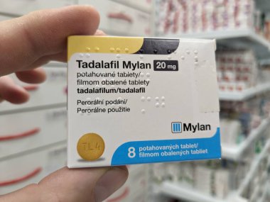 Prague, Czech Republic - SEPTEMBER 13 2024: TADALAFIL MYLAN box of medication with TADALAFIL active substance by MYLAN, used for treatment of erectile dysfunction and benign prostatic hyperplasia. clipart