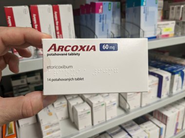 Prague, Czech Republic - July 10 2024: ARCOXIA box of medication with ETORICOXIB active substance by MERCK, used for treatment of pain and inflammation in arthritis. clipart