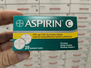 Prague, Czech Republic - July 10 2024: ASPIRIN box of medication with ACETYLSALICYLIC ACID active substance by BAYER, used for pain relief, fever reduction, and cardiovascular disease prevention. clipart