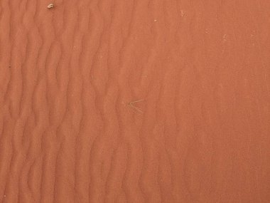 Turuncu renkli kum desenli arka plan. Wadi Rum Çölü, Ürdün, Arabistan manzaralı güzel manzara, çölde kırmızı portakallı kuma yakın çekim