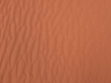 Turuncu renkli kum desenli arka plan. Wadi Rum Çölü, Ürdün, Arabistan manzaralı güzel manzara, çölde kırmızı portakallı kuma yakın çekim