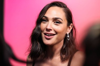 Israeli actress Gal Gadot (Gal Gadot-Varsano) wearing Michael Kors Collection with a Tyler Ellis bag arrives at the Veuve Clicquot 250th Anniversary Solaire Culture Exhibition Opening held at 468 North Rodeo Drive on October 25, 2022 in LA, USA. clipart