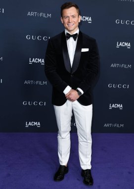 Taron Egerton, Gucci 'nin 5 Kasım 2022' de Los Angeles İlçe Sanat Müzesi 'nde sunduğu 11. LACMA Sanat + Film Galası 2022' ye geliyor..