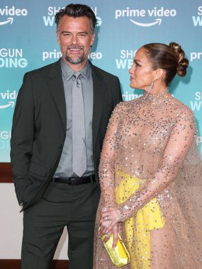 Josh Duhamel and  Jennifer Lopez (J.Lo) wearing a Valentino sheer dress and Tyler Ellis clutch arrive at the Los Angeles Premiere Of Amazon Prime Video's 'Shotgun Wedding' on January 18, 2023 in Hollywood, Los Angeles clipart