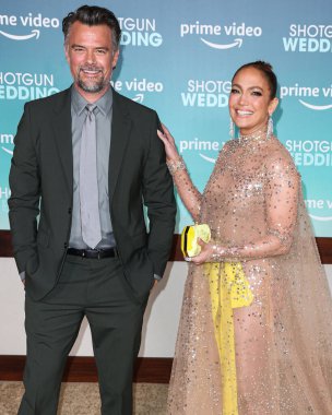 Josh Duhamel and  Jennifer Lopez (J.Lo) wearing a Valentino sheer dress and Tyler Ellis clutch arrive at the Los Angeles Premiere Of Amazon Prime Video's 'Shotgun Wedding' on January 18, 2023 in Hollywood, Los Angeles