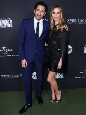American actor Adrien Brody and girlfriend/English fashion designer and actress Georgina Chapman arrive at the Universal Music Group 2023 65th GRAMMY Awards After Party held at Milk Studios Los Angeles on February 5, 2023 in Los Angeles, California