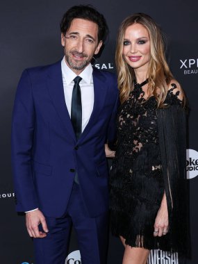 American actor Adrien Brody and girlfriend/English fashion designer and actress Georgina Chapman arrive at the Universal Music Group 2023 65th GRAMMY Awards After Party held at Milk Studios Los Angeles on February 5, 2023 in Los Angeles, California