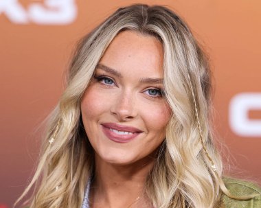 American model Camille Kostek arrives at the Los Angeles Premiere Of Netflix's 'Outer Banks' Season 3 held at the Regency Village Theatre on February 16, 2023 in Westwood, Los Angeles, California, United States. 