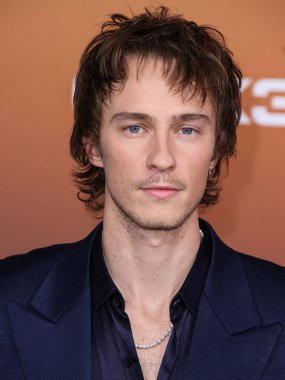 American actor Drew Starkey arrives at the Los Angeles Premiere Of Netflix's 'Outer Banks' Season 3 held at the Regency Village Theatre on February 16, 2023 in Westwood, Los Angeles, California, United States. 