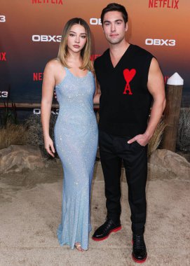 Madelyn Cline and Austin North arrive at the Los Angeles Premiere Of Netflix's 'Outer Banks' Season 3 held at the Regency Village Theatre on February 16, 2023 in Westwood, Los Angeles, California, United States.