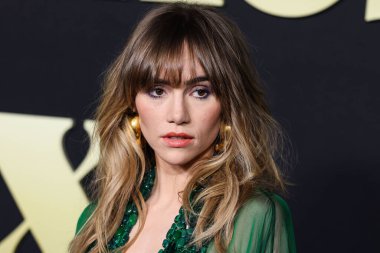 English model, actress and singer Suki Waterhouse wearing a Stephane Rolland gown, a Tyler Ellis bag, and Misho jewelry arrives at the Los Angeles Premiere Of Amazon Prime Video's 'Daisy Jones & The Six' Season 1 on February 23, 2023