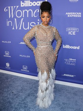 Chloe Bailey wearing a Giambattista Valli dress and Jacob and Co. jewelry arrives at the 2023 Billboard Women In Music held at the YouTube Theater on March 1, 2023 in Inglewood, Los Angeles, California, United States.  clipart