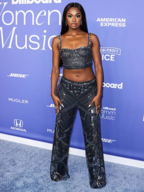 Coco Jones wearing a Cucculelli Shaheen Collection crop top and pants arrives at the 2023 Billboard Women In Music held at the YouTube Theater on March 1, 2023 in Inglewood, Los Angeles, California, United States.