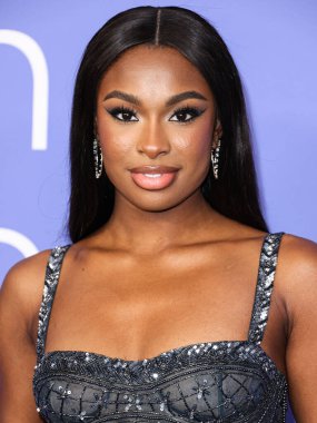 Coco Jones wearing a Cucculelli Shaheen Collection crop top and pants arrives at the 2023 Billboard Women In Music held at the YouTube Theater on March 1, 2023 in Inglewood, Los Angeles, California, United States.