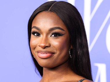 Coco Jones wearing a Cucculelli Shaheen Collection crop top and pants arrives at the 2023 Billboard Women In Music held at the YouTube Theater on March 1, 2023 in Inglewood, Los Angeles, California, United States.