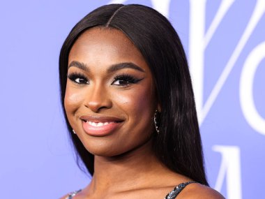 Coco Jones wearing a Cucculelli Shaheen Collection crop top and pants arrives at the 2023 Billboard Women In Music held at the YouTube Theater on March 1, 2023 in Inglewood, Los Angeles, California, United States.