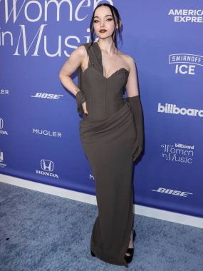 Dove Cameron wearing a Jacquemus dress, Giuseppe Zanotti shoes, and Tyler Ellis clutch arrives at the 2023 Billboard Women In Music held at the YouTube Theater on March 1, 2023 in Inglewood, Los Angeles, California, United States. 