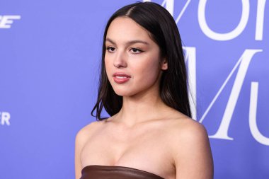 Olivia Rodrigo wearing a Jacquemus dress, Giuseppe Zanotti shoes, and Tyler Ellis clutch arrives at the 2023 Billboard Women In Music held at the YouTube Theater on March 1, 2023 in Inglewood, Los Angeles, California, United States. 