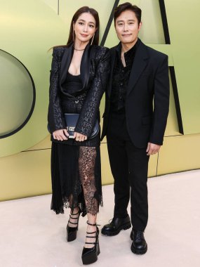 Lee Min-jung and husband Lee Byung-hun arrive at the Versace Fall/Winter 2023 Fashion Show held at the Pacific Design Center on March 9, 2023 in West Hollywood, Los Angeles, California, United States.  clipart