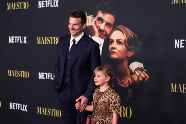 American actor and filmmaker Bradley Cooper wearing a Louis Vuitton suit and daughter Lea De Seine Shayk Cooper arrive at the Los Angeles Special Screening Of Netflix's 'Maestro' held at the Academy Museum of Motion Pictures on December 12, 2023  clipart