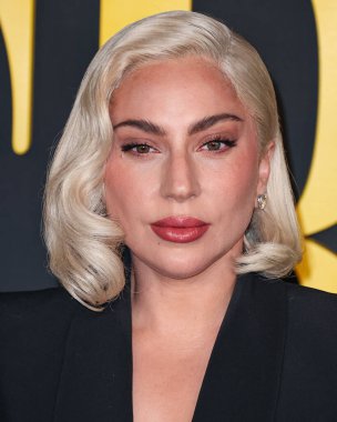 Lady Gaga (Stefani Joanne Angelina Germanotta) wearing an Alexander McQueen suit arrives at the Los Angeles Special Screening Of Netflix's 'Maestro' held at the Academy Museum of Motion Pictures on December 12, 2023 in Los Angeles clipart