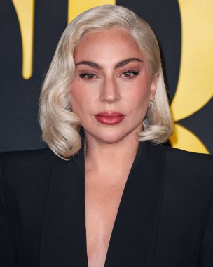 Lady Gaga (Stefani Joanne Angelina Germanotta) wearing an Alexander McQueen suit arrives at the Los Angeles Special Screening Of Netflix's 'Maestro' held at the Academy Museum of Motion Pictures on December 12, 2023 in Los Angeles clipart