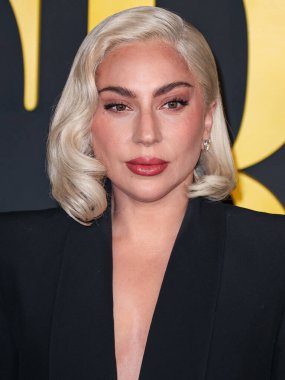 Lady Gaga (Stefani Joanne Angelina Germanotta) wearing an Alexander McQueen suit arrives at the Los Angeles Special Screening Of Netflix's 'Maestro' held at the Academy Museum of Motion Pictures on December 12, 2023 in Los Angeles clipart