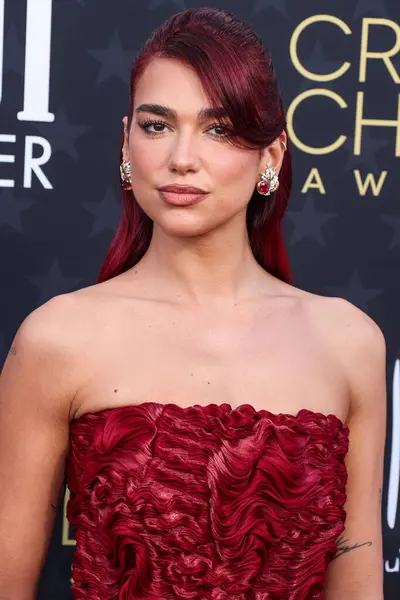 stock image Dua Lipa wearing a custom Prada dress, Prada shoes and bag, and Tiffany and Co. jewelry arrives at the 29th Annual Critics' Choice Awards held at The Barker Hangar on January 14, 2024 in Santa Monica, Los Angeles, California, United States.