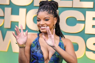 Halle Bailey wearing an archive Roberto Cavalli dress with Jimmy Choo shoes and Kallati jewelry arrives at the 49th Annual People's Choice Awards 2024 held at The Barker Hangar on February 18, 2024 in Santa Monica, Los Angeles, California clipart