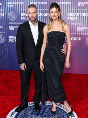 Behati Prinsloo and wife Adam Levine arrive at the 10th Annual Breakthrough Prize Ceremony held at the Academy Museum of Motion Pictures on April 13, 2024 in Los Angeles, California, United States. clipart