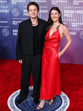 Charlie Puth and girlfriend Brooke Sansone arrive at the 10th Annual Breakthrough Prize Ceremony held at the Academy Museum of Motion Pictures on April 13, 2024 in Los Angeles, California, United States.