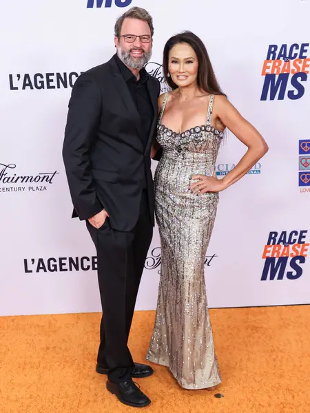 stock image Paul Debevec and Tia Carrere arrive at the 31st Annual Race To Erase MS Gala 2024 held at the Fairmont Century Plaza on May 10, 2024 in Century City, Los Angeles, California, United States. 