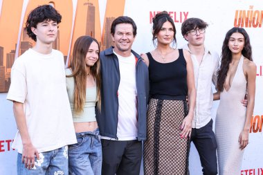 Mark Wahlberg, wife Rhea Durham, son Michael Wahlberg and Sunni Gaines arrive at the Los Angeles Premiere Of Netflix's 'The Union' held at The Egyptian Theatre Hollywood on August 12, 2024 in Hollywood, Los Angeles, California, United States.  clipart