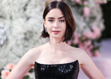 Lily Collins wearing a custom Armani Prive dress arrives at the Los Angeles Premiere Of Netflix's 'Emily In Paris' Season 4 Part 1 held at The Egyptian Theatre Hollywood on August 14, 2024 in Hollywood, Los Angeles, California, United States.  clipart