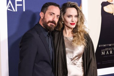 Pablo Larrain and Angelina Jolie arrive at the 2024 AFI Fest - Premiere Screening Of Netflix's 'Maria' held at the TCL Chinese Theatre IMAX on October 26, 2024 in Hollywood, Los Angeles, California, United States. clipart