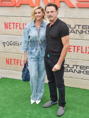 Brianna Brown and Tony Crane arrive at Netflix's Poguelandia 2024 Event Celebrating 'Outer Banks' Season 4 Part 2 held at Barker Hangar on November 2, 2024 in Santa Monica, Los Angeles, California, United States. clipart