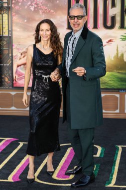 Emilie Livingston and husband Jeff Goldblum arrive at the Los Angeles Premiere Of Universal Pictures' 'Wicked' held at the Dorothy Chandler Pavilion at The Music Center on November 9, 2024 in Los Angeles, California, United States. clipart