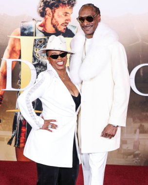 Shante Broadus and husband Snoop Dogg (Calvin Broadus Jr.) arrive at the Los Angeles Premiere Of Paramount Pictures' 'Gladiator II' held at the TCL Chinese Theatre IMAX on November 18, 2024 in Hollywood, Los Angeles, California, United States.  clipart