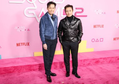 Lee Jung-jae and Lee Byung-hun arrive at the Los Angeles Premiere And Fan Event For Netflix's 'Squid Game' Season 2 held at the Los Angeles City College on December 12, 2024 in Los Angeles, California, United States.  clipart