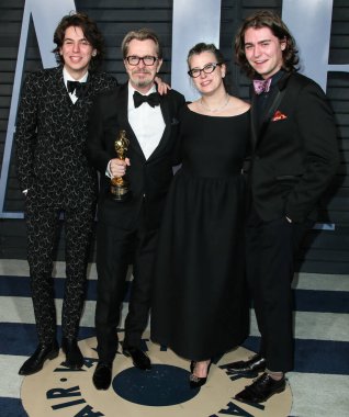 ('I' m Gobsmacked ': Sir Gary Oldman, Kral III. Charles tarafından Şövalye Olmak Hakkında Açılıyor. BEVERLY HILLS, LOS ANGELES, CALIFORNIA, ABD - 04 Mart: Gulliver Oldman, Gisele Schmidt, İngiliz aktör, yönetmen ve müzisyen Gary Oldman